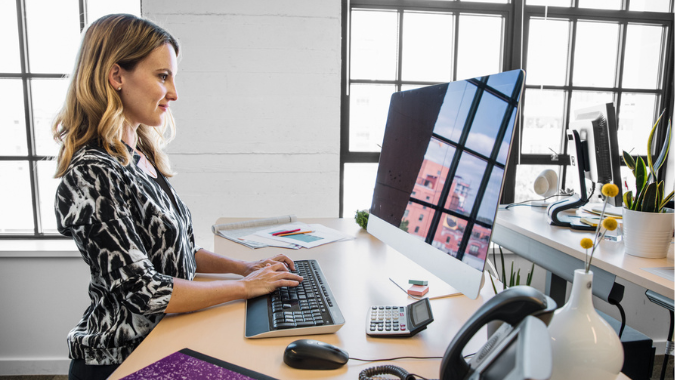 Woman working at a desktop computer